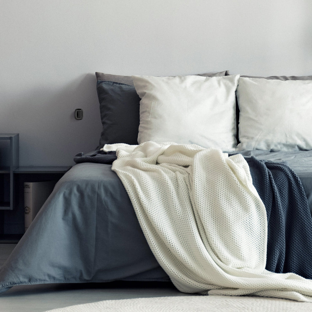 
                  
                    a bed with a AJAX Smart Button installed on the wall beside
                  
                